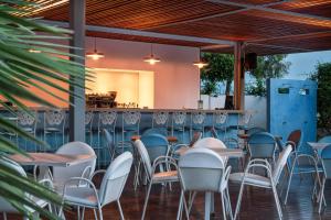 een rij tafels en stoelen aan een bar bij Danae Hotel in Aegina Town