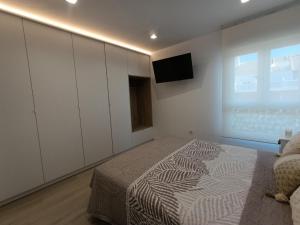 Ένα ή περισσότερα κρεβάτια σε δωμάτιο στο Apartamento Suite Frente al Mar +39 φωτογραφίες