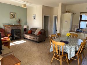 a living room with a table and a couch at Cloonkee Cottage in Crossmolina