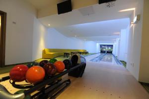 a bowling alley with pins and a bowling alley at Pension Lidana Resort & SPA in Vama