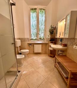 a bathroom with a toilet and a sink at La Magnolia in Livorno