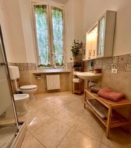 a bathroom with a toilet and a sink at La Magnolia in Livorno