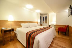 Postel nebo postele na pokoji v ubytování Hotel Plaza de Armas Cusco