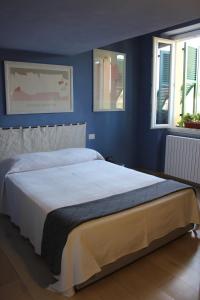 ein Schlafzimmer mit einem großen Bett mit blauen Wänden in der Unterkunft Verdemare e Verdementa in Porto Venere