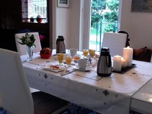 a table with a white table cloth with candles on it at Villa du Canal in Toulouse