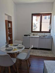 a room with a table and chairs and a kitchen at Konak II in Plav +23 photos