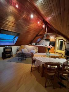 a living room with a table and a couch at Appartement à la campagne in Bournainville