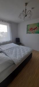 a bedroom with a bed and a ceiling fan at Ferienwohnung für bis zu 10 Personen in Koetz 