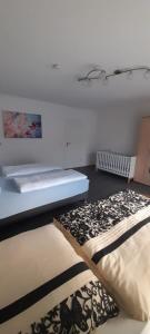 two beds sitting in a room with a table at Ferienwohnung für bis zu 10 Personen in Koetz 