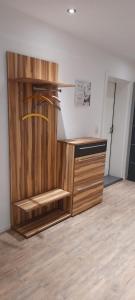 a wooden cabinet with a sink in a room at Ferienwohnung für bis zu 10 Personen in Koetz 
