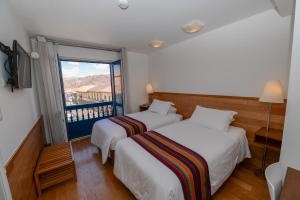 Postel nebo postele na pokoji v ubytování Hotel Plaza de Armas Cusco