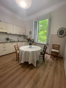 a kitchen with a table and chairs in a room at La Magnolia in Livorno