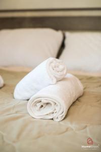 a stack of towels sitting on top of a bed at Sea Side House in Nea Chili