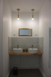 a bathroom with two sinks and a mirror at Les Chambres d'Emma in Le Liège +40 photos