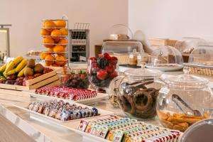 a buffet filled with different types of food on a counter at Danae Hotel in Egina