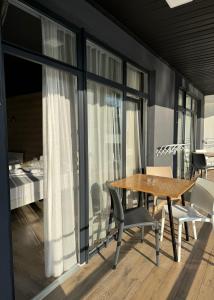 a dining room with a wooden table and chairs at Modern House in Solotvyno +35 photos