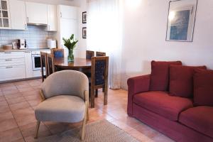 a living room with a red couch and a table at Holiday Home “Vuko” in Trilj