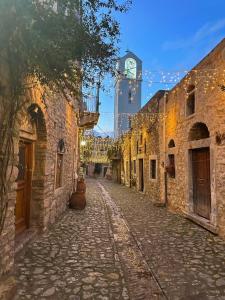 an empty street with a clock tower in the background at Voltes Mesta in Mestá