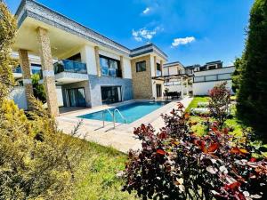 an exterior view of a house with a swimming pool at Villa Bella in Kuşadası