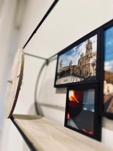two pictures of a building are on a wall at Sotto l'Arco in Acireale