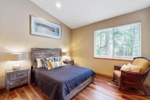 a bedroom with a bed and a chair and a window at Cochise Adventures in South Lake Tahoe