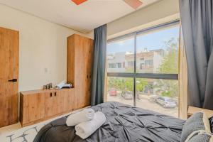 En eller flere senge i et værelse på Downtown Aldea Zama Luxury Condo