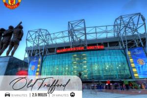 a stadium with a statue in front of it at Modern 1-Bed Apartment - City Centre - FREE Wi-Fi - New - in Manchester