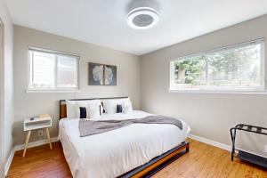 a bedroom with a large bed and two windows at Escape at Edgewood in Stateline