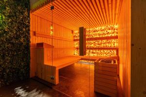 a sauna with a bench in a room with lights at Góralski Resort Pool & SPA in Białka Tatrzanska