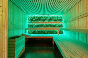 a room with a green bench in a building at Góralski Resort Pool & SPA in Białka Tatrzanska