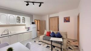 a living room with a couch and a kitchen at BOKI apartments in Bijela