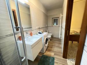 a bathroom with a sink and a washing machine at La Casa della Campana in Cortona +33 photos