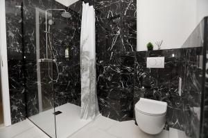 a black bathroom with a toilet and a shower at New,Modern apartment near Split andTrogir in Kaštela +59 photos