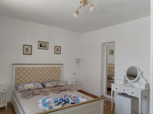 a bedroom with a bed and a mirror in it at Стаи за гости Гергана град Созопол in Sozopol