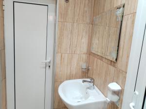 a bathroom with a sink and a mirror at Стаи за гости Гергана град Созопол in Sozopol