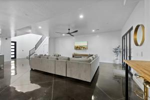 a living room with a couch and a ceiling fan at The Millie at Sand Hollow in Hurricane +53 photos