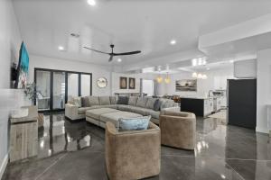 a living room with a couch and chairs and a kitchen at The Millie at Sand Hollow in Hurricane