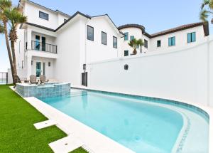 a swimming pool in the backyard of a house at Queen Of Crystal Shores Luxury Beachfront Retreat in Destin