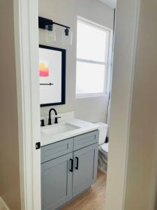a white bathroom with a sink and a window at Hurricane Hideaway in Hurricane
