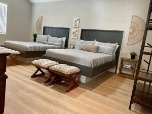 a bedroom with two beds and two chairs at Hurricane Hideaway in Hurricane +43 photos