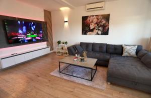 a living room with a couch and a flat screen tv at New,Modern apartment near Split andTrogir in Kaštela