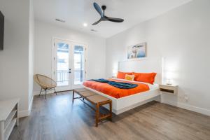 a white bedroom with an orange bed and a ceiling fan at Just Beachy at Sand Hollow in Hurricane +38 photos