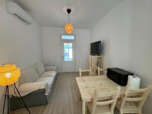 a living room with a couch and a table at Apartamento Búho - Junto al Castillo in Antequera