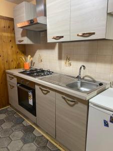 a kitchen with a sink and a stove at Casa Carolina in Collepasso +13 photos