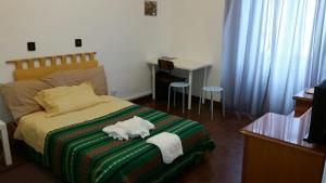 a bedroom with a bed with a stuffed animal on it at Il Cucù in Frascati