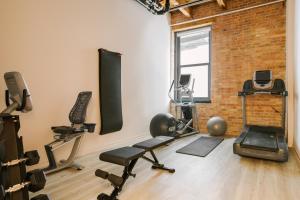 a gym with exercise equipment and a brick wall at Sonder The Burnham in Chicago