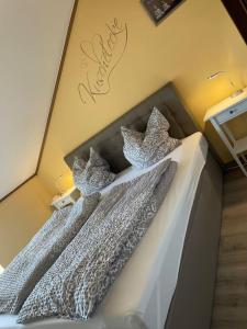 two beds with white comforters in a bedroom at FeWo 57 - Appartement im Rottalblick - Helle Kuschelecke genießen mit Bademantelgang zur Therme, TV, inkl Stellplatz im Haus u Kurtaxe in Bad Griesbach