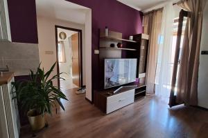 a living room with a flat screen tv on a entertainment center at Apartman Lila in Poreč