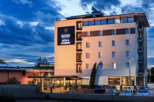 a rendering of the granary hotel at dusk at Hotel Gatsby by HappyCulture in Chassieu