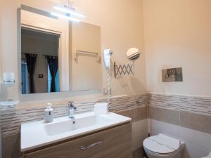 Un baño con lavabo, inodoro y espejo. en B&B Dionea, en Santa Maria di Castellabate 69 fotos más